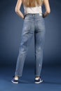 Young fashion woman`s legs in blue denim jeans Royalty Free Stock Photo