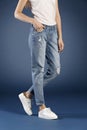 Young fashion woman`s legs in blue denim jeans Royalty Free Stock Photo