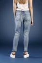 Young fashion woman`s legs in blue denim jeans Royalty Free Stock Photo