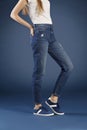 Young fashion woman`s legs in blue denim jeans Royalty Free Stock Photo