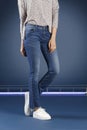 Young fashion woman`s legs in blue denim jeans Royalty Free Stock Photo