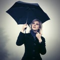 Young fashion woman with umbrella walking in a fog outdoor Royalty Free Stock Photo