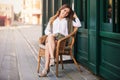 Young fashion woman in white shirt sitting on wicker chair Royalty Free Stock Photo