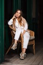 Young fashion woman in white shirt sitting on wicker chair Royalty Free Stock Photo