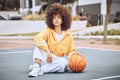 Young, fashionable and beautiful black woman basketball player or athlete with afro sitting on a court ground. Portrait Royalty Free Stock Photo