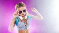 Young fashionable girl in disco style. Listening music and enjoying. Royalty Free Stock Photo