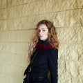 Young fashionable girl with long curly hair