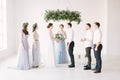 Young fashionable lovely couple together with bridesmaids and groommen with speech master of wedding ceremony against Royalty Free Stock Photo