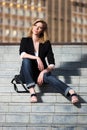 Young fashionable woman sitting on the steps Royalty Free Stock Photo