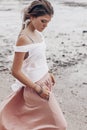 Beautiful young fashionable woman walking by the shore line Royalty Free Stock Photo