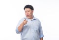 Young Fat Asian business man pointing to camera with funny face isolated on white background.