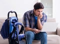 Young father assembling baby pram at home