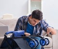 Young father assembling baby pram at home