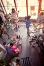 Young father buying new bicycle for little girl in bike shop top view