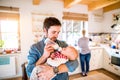 Young father carrying and feeding his newborn baby son Royalty Free Stock Photo