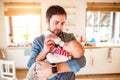 Young father carrying and feeding his newborn baby son Royalty Free Stock Photo