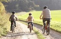 Young father with children ride bikes in park