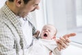 Young father copying son while he yawning