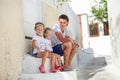 Young father and cute daughters sitting on Royalty Free Stock Photo