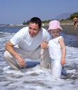 Young Father and Daughter on beach on vacation