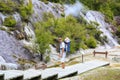 Young father with daughter observing Thermal area Orakei Korako, NZ