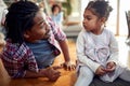 A young father is full of emotions while chatting and playing with his daughter at home. Family, together, love, playtime