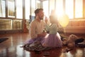 The young father is full of joy when his daughter puts on make-up on him while they preparing for a ballet practice at home.