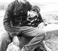 Young father hipster with a beard and his little son on the lake shore. Talking, teaching, having fun happy time Royalty Free Stock Photo