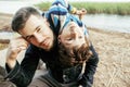 Young father hipster with a beard and his little son on the lake shore. Talking, teaching, having fun happy time Royalty Free Stock Photo