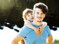 Young father hipster with a beard and his little son on the lake shore. Talking, teaching, having fun happy time Royalty Free Stock Photo