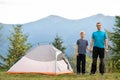 Young father and his child son hiking together in summer mountains. Active family on camping trip Royalty Free Stock Photo