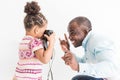 Young father with his cute little daughter taking pictures of each other on an old vintage camera Royalty Free Stock Photo