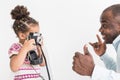 Young father with his cute little daughter taking pictures of each other on an old vintage camera Royalty Free Stock Photo