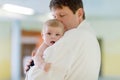 Young father and his little cute newborn baby daughter together in spa hotel. Royalty Free Stock Photo