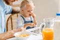 Young father and his little daughter having breakfast and using tablet computer at home Royalty Free Stock Photo