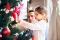 Young father with daugter decorating Christmas tree together. Royalty Free Stock Photo