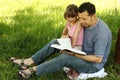 Young father with his little daughter reading the Bible Royalty Free Stock Photo