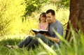 Young father with his little daughter reading the Bible Royalty Free Stock Photo