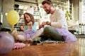 A young father and his little daughter spending a quality time together while preparing for a ballet training at home. Family,