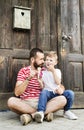 Young father and his little son eating ice cream. Sunny day. Royalty Free Stock Photo
