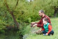 Young father and his son fishing together Royalty Free Stock Photo