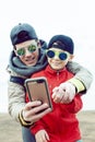 young father with his son having fun outside in spring field, happy family smiling, lifestyle people making selfie Royalty Free Stock Photo