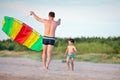 Young father and his son playing with kite Royalty Free Stock Photo