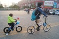 Young father and his son riding a bike together