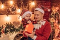 Young father and his son in Santa`s hat open a Christmas gift present box. Winter holidays and childhood concept Royalty Free Stock Photo