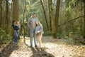 Young father and his three kids hiking in the woods. Family of four having fun on a walking trail on sunny spring day Royalty Free Stock Photo