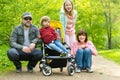 Young father and his three kids hiking in the woods. Family of four having fun on a walking trail on sunny spring day Royalty Free Stock Photo