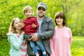 Young father and his three kids hiking in the woods. Family of four having fun on a walking trail on sunny spring day Royalty Free Stock Photo