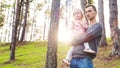 Young father holding cute toddler daughter in his arm while on a walk in a forest Royalty Free Stock Photo