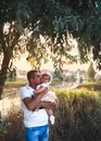 Young father holding his baby girl outside in the park Royalty Free Stock Photo